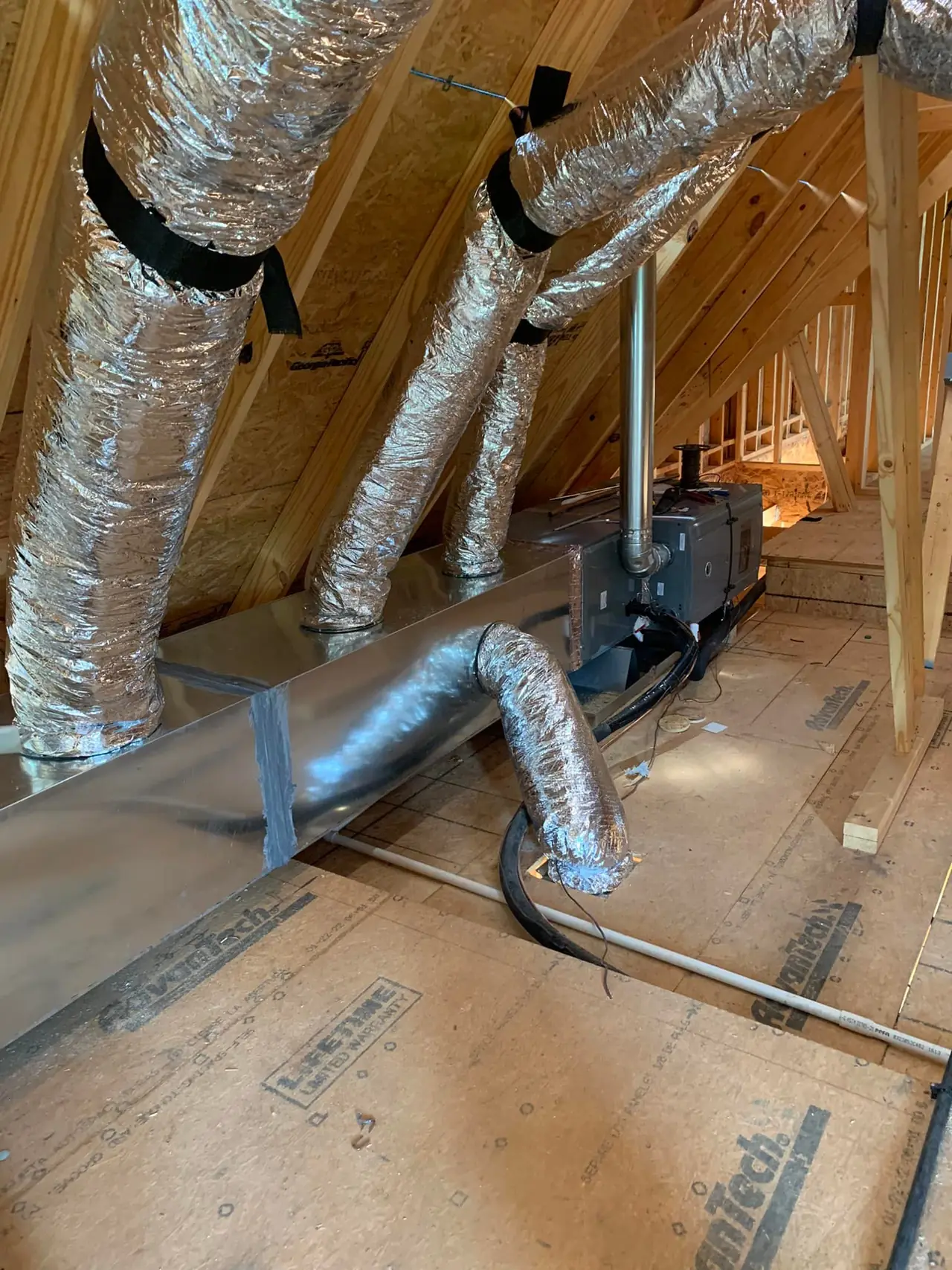 Insulated flex duct runs in a residential attic
