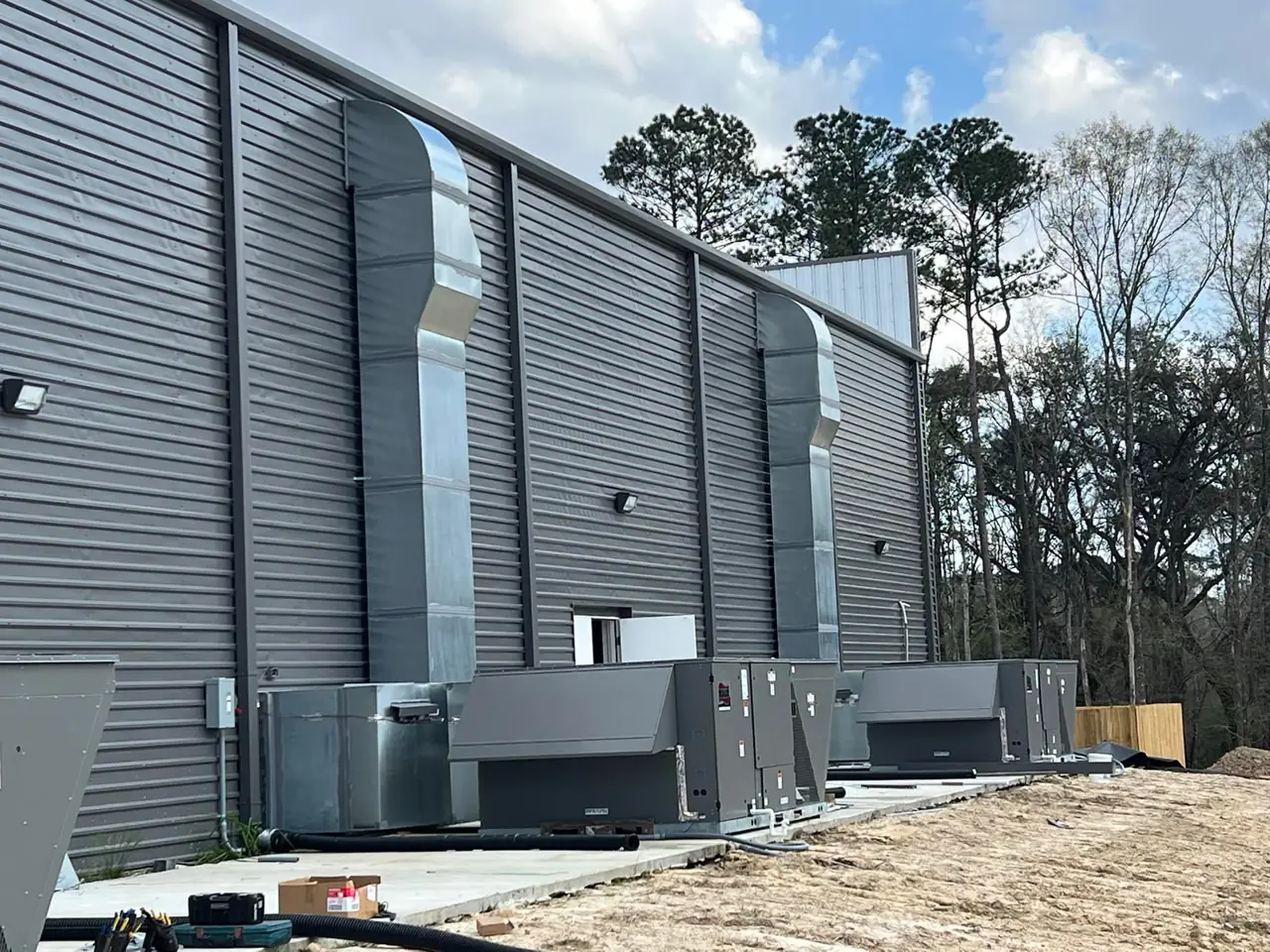 Exterior ductwork and HVAC units on a new commercial building