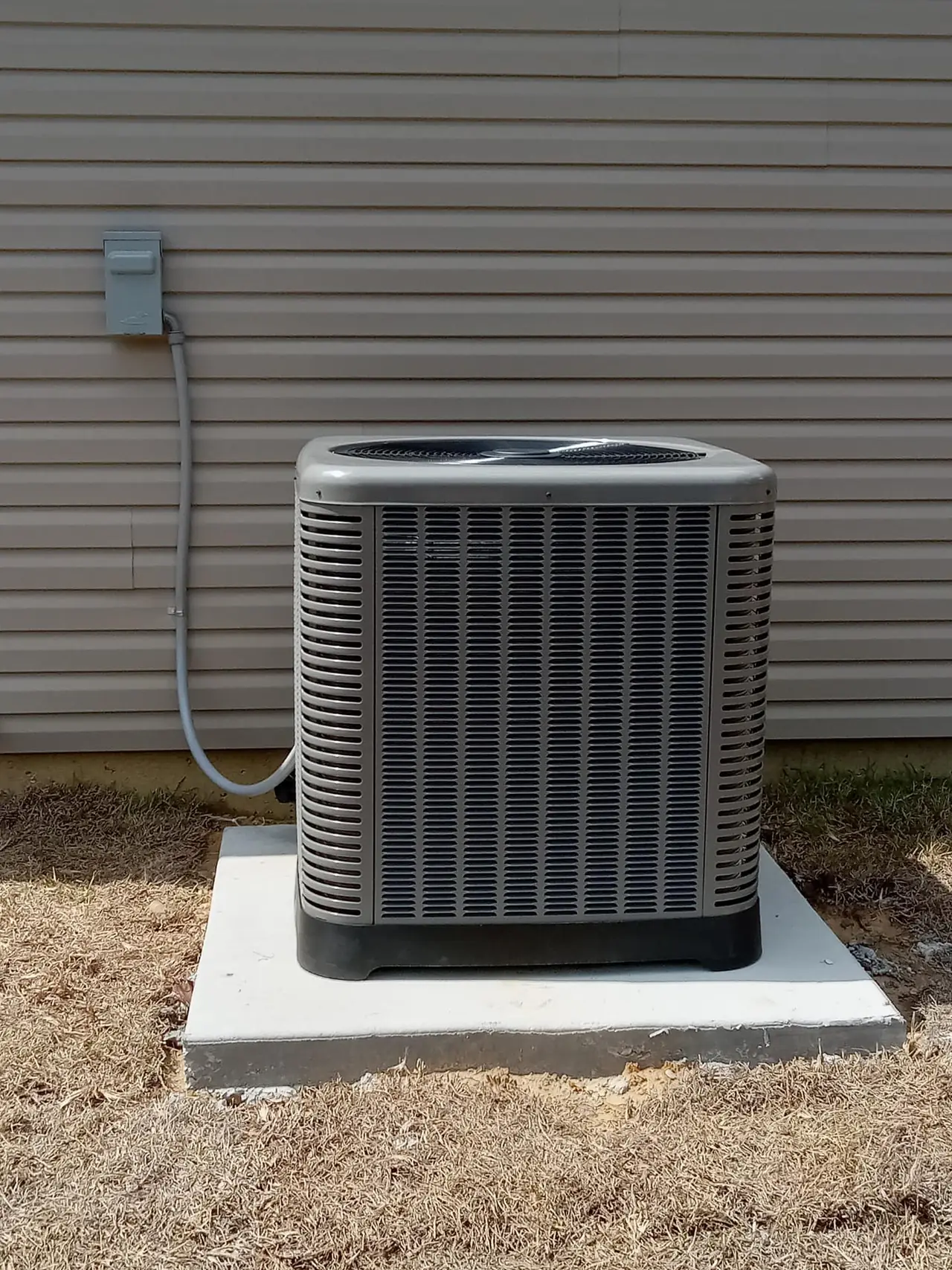 New AC condenser on a concrete pad