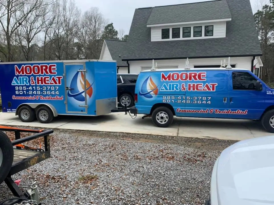 Moore Air & Heat van and trailer at a residential job